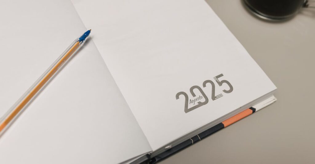 Open 2025 planner with a pen and coffee cup on a desk, ideal for productivity themes.